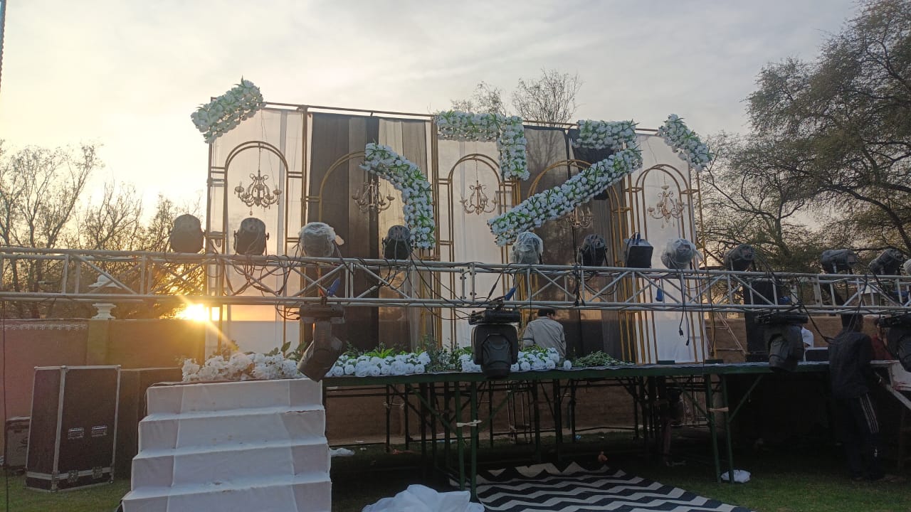 Floral column stage white strand curtain night