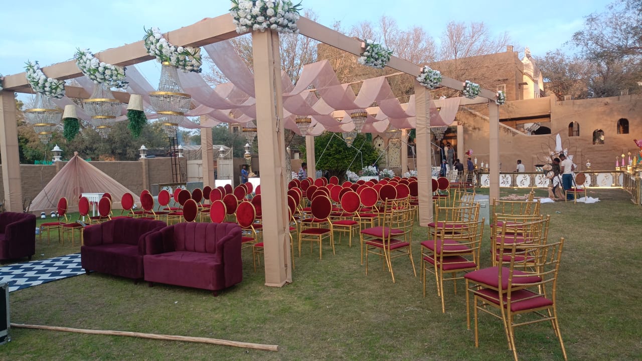 Pergola outdoor ceremony pink draping chandeliers